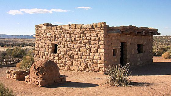 A traditional Hualapai stone and earth home with an outdoor oven in the high desert