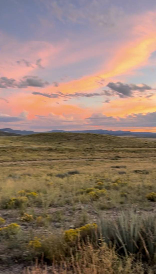 Pink and orange sunset over high desert grassland
